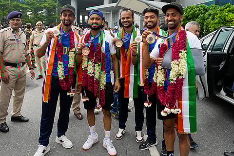 Indian Hockey players pose with bronze medal outside IGI airport